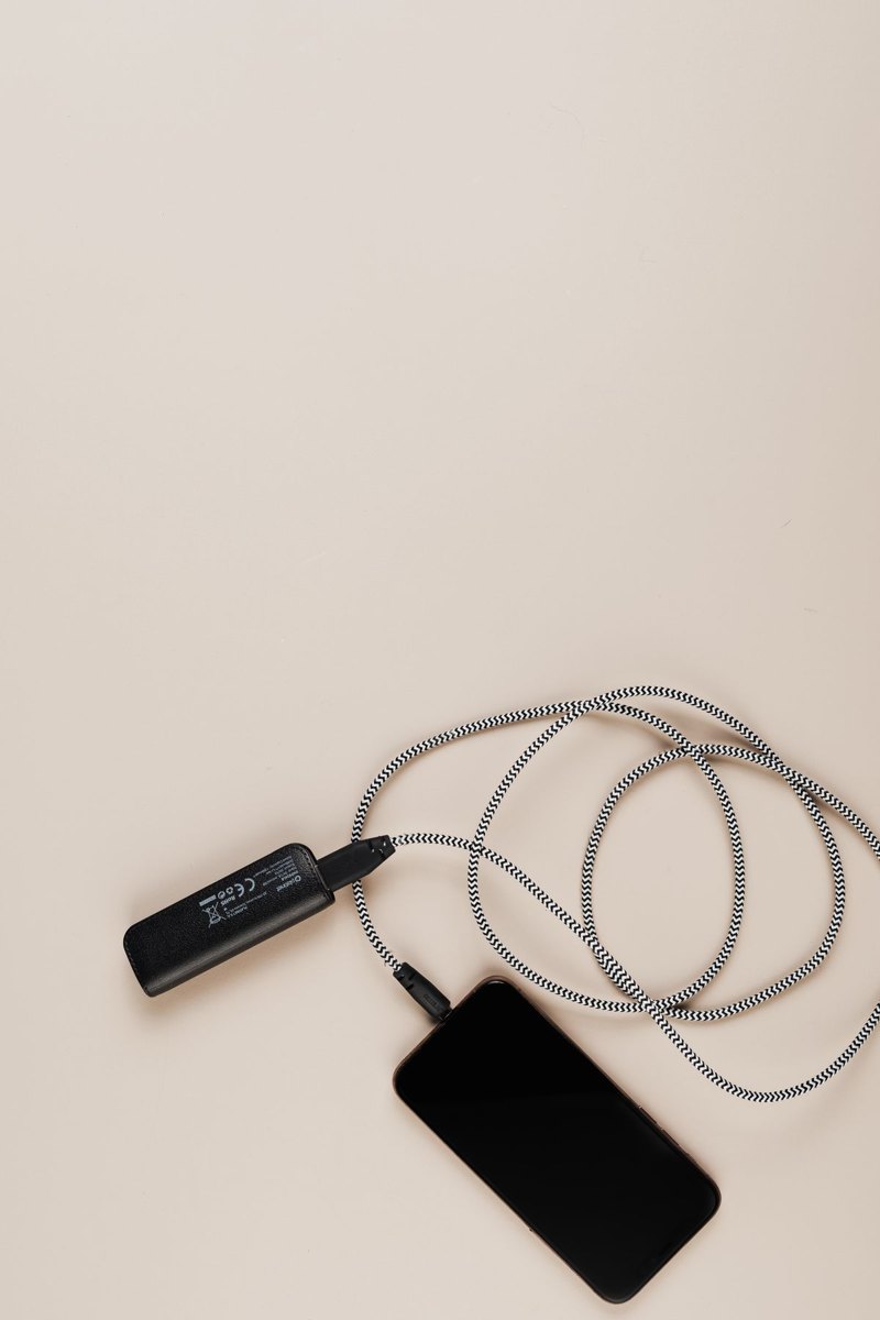 Phone connected to a power bank by a charging cable