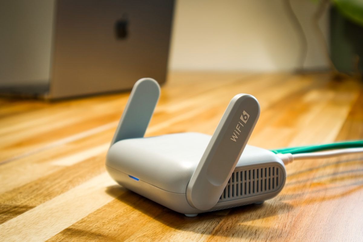 Wireless router and network cable on a wooden desk