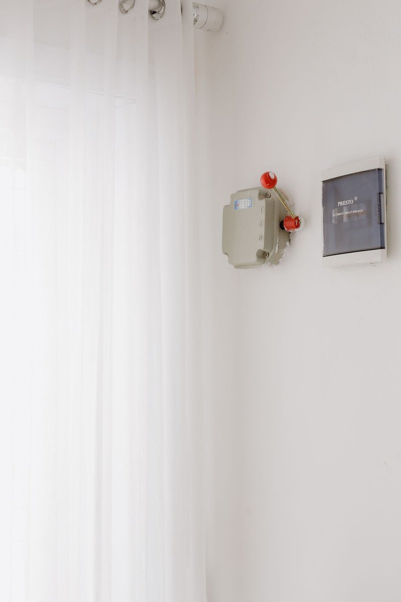 Closed electrical distribution panel mounted on an interior wall