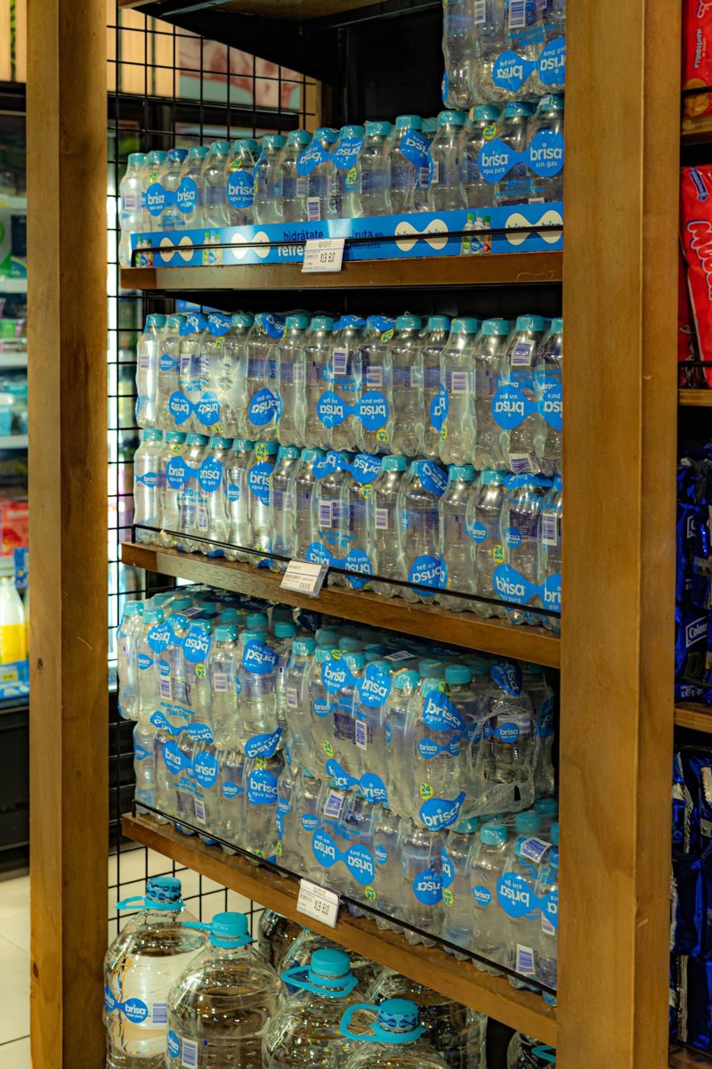 Rows of sealed drinking water bottles with labels