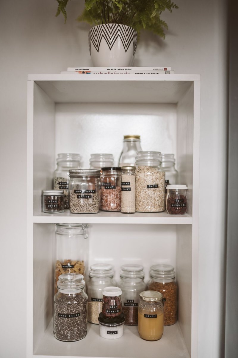 Organized pantry shelves with labeled food jars