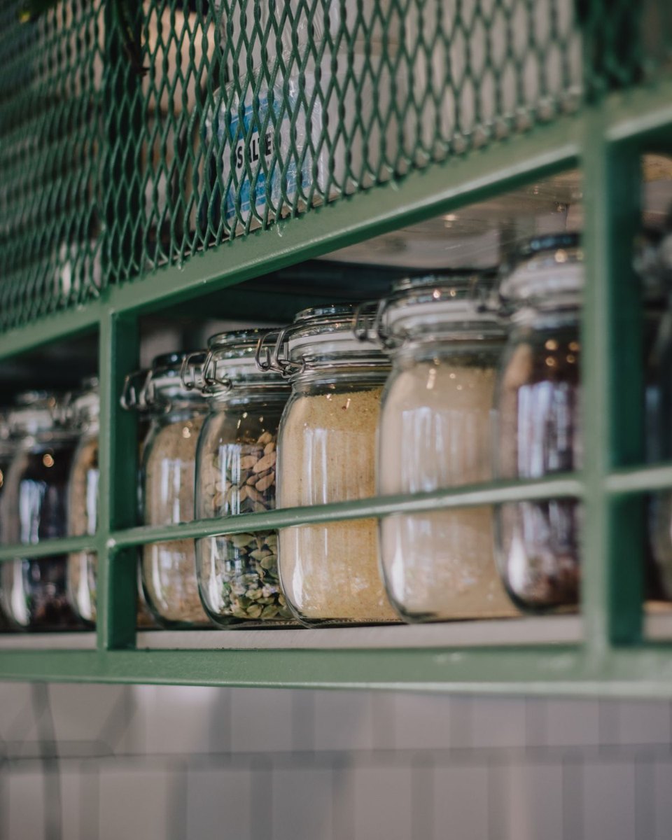 Closed jars holding dry ingredients on a kitchen rack