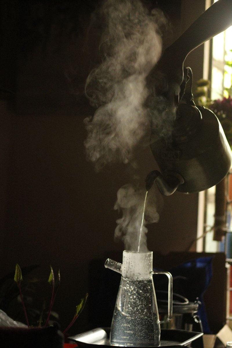 Steaming water being poured from a kettle