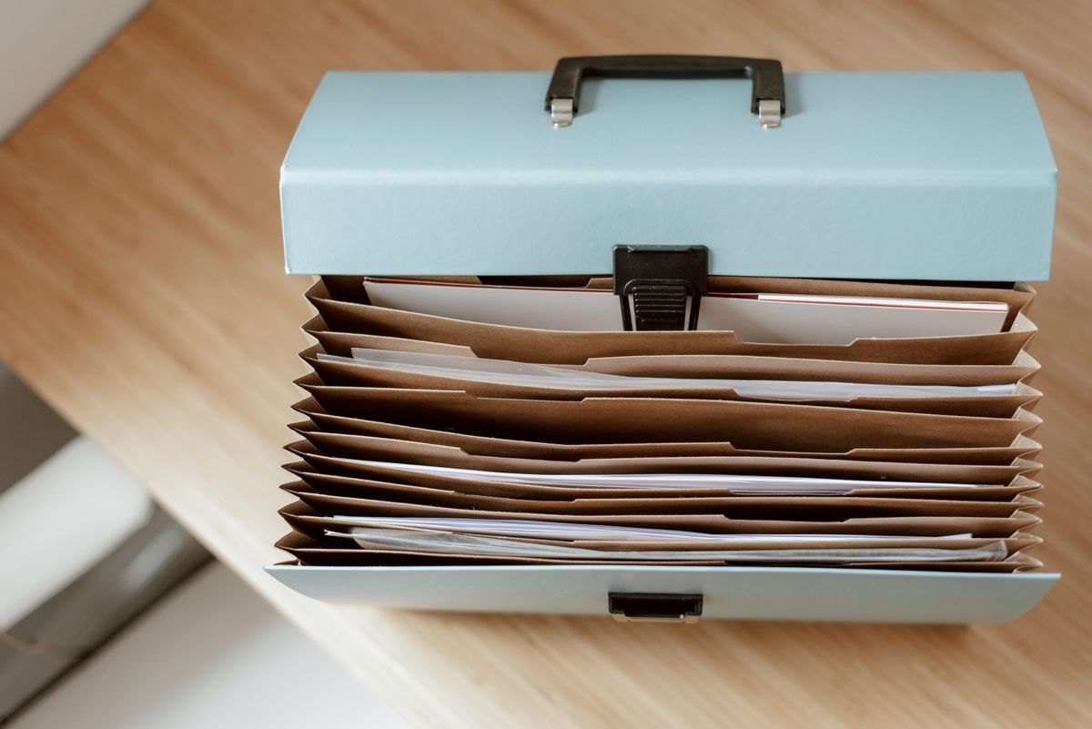 Document folder and papers laid open on a table