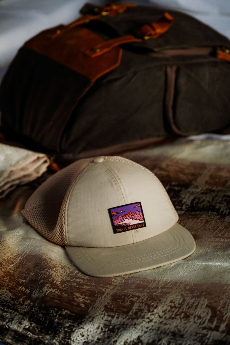 Backpack and hat laid ready on a bed