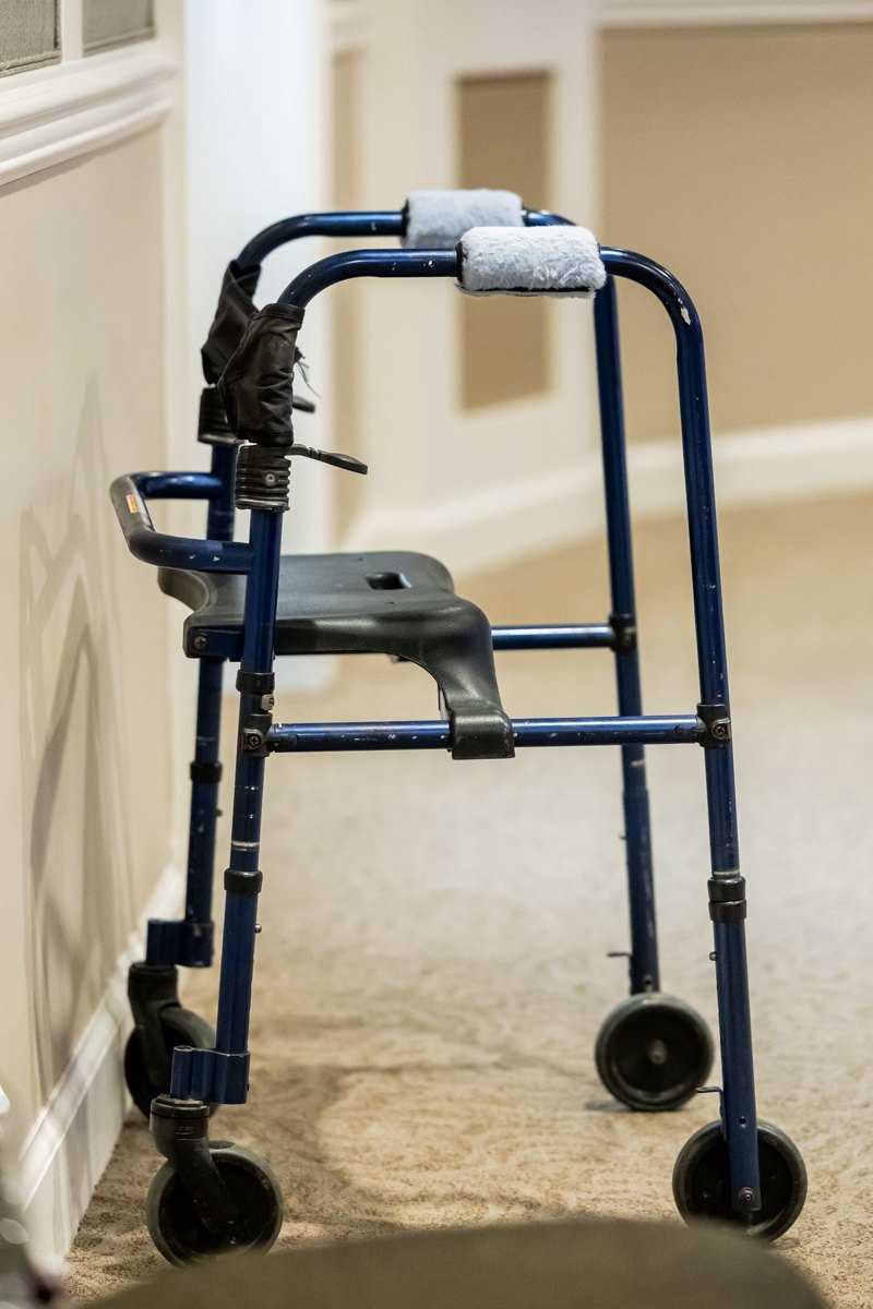 Wheeled walking frame beside a clear indoor hallway