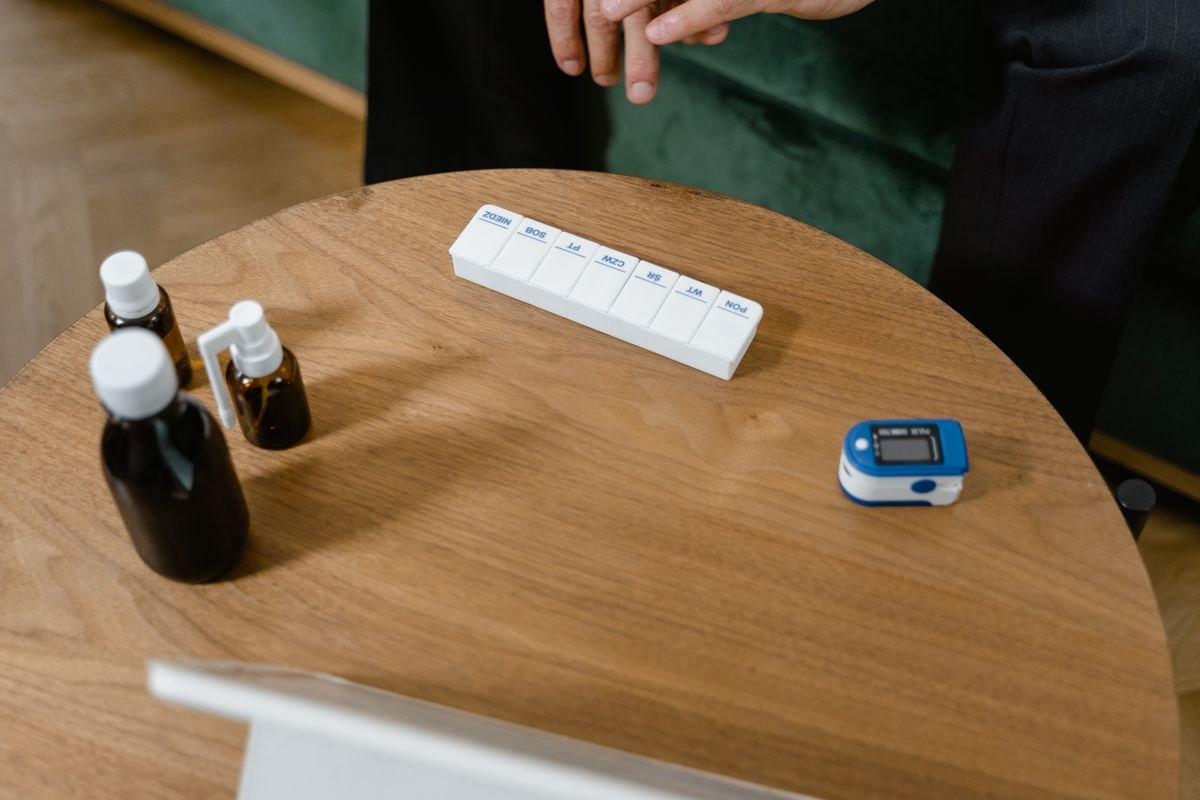 Medication bottles and organizer on a table