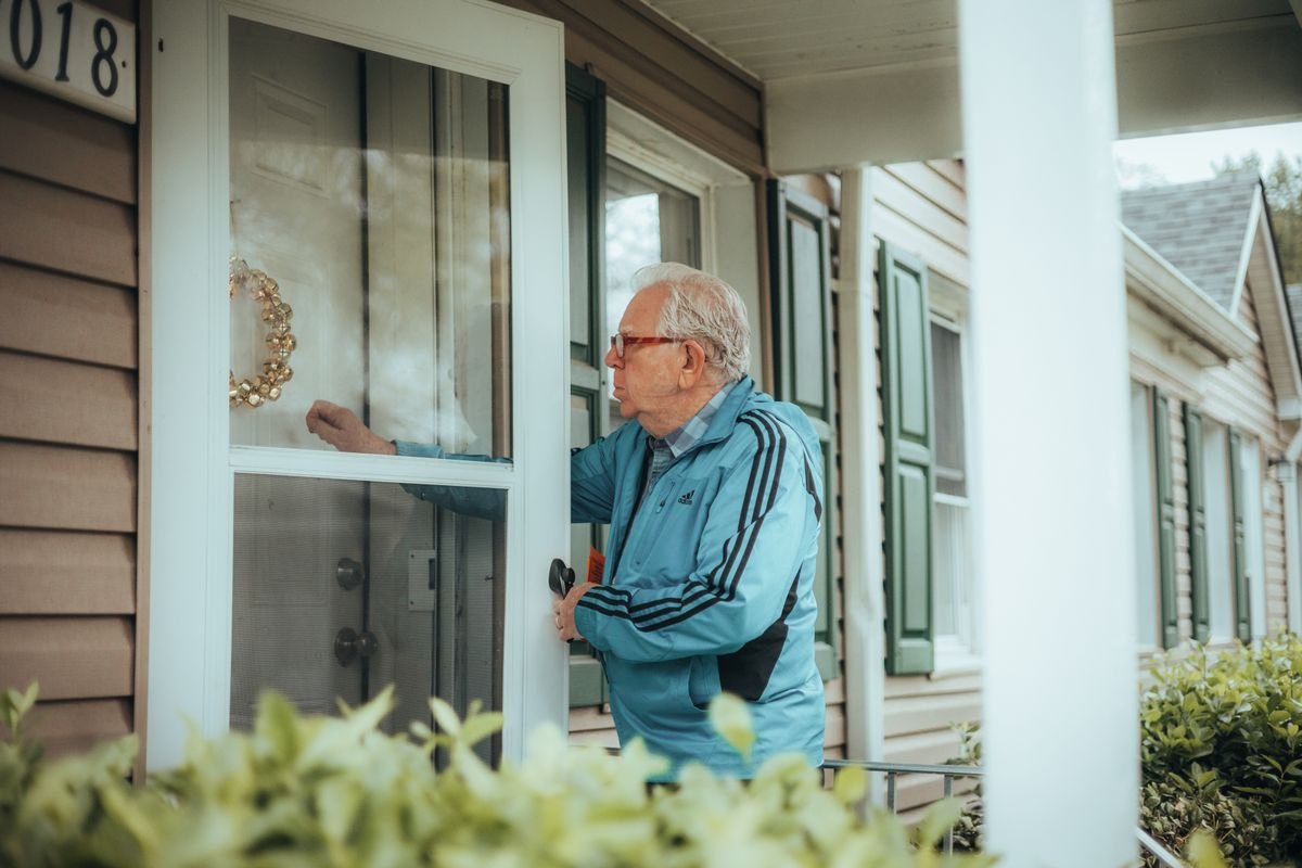 Neighbor knocking on a residential front door