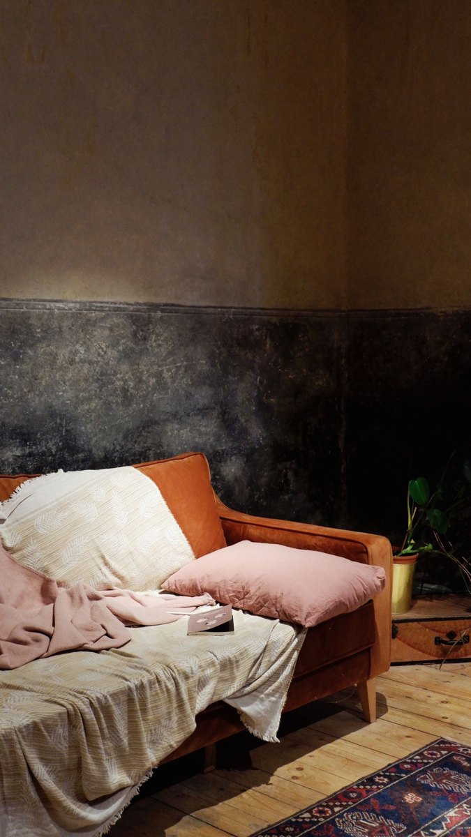 Blankets and cushions set out on a household sofa