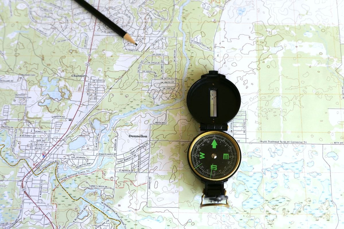 Topographic map with compass and pencil