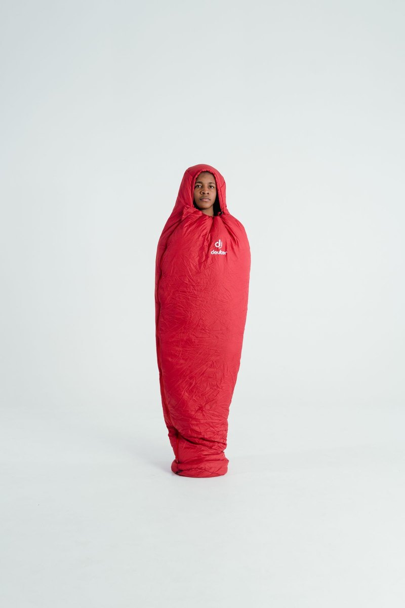 Person standing wrapped in a sleeping bag