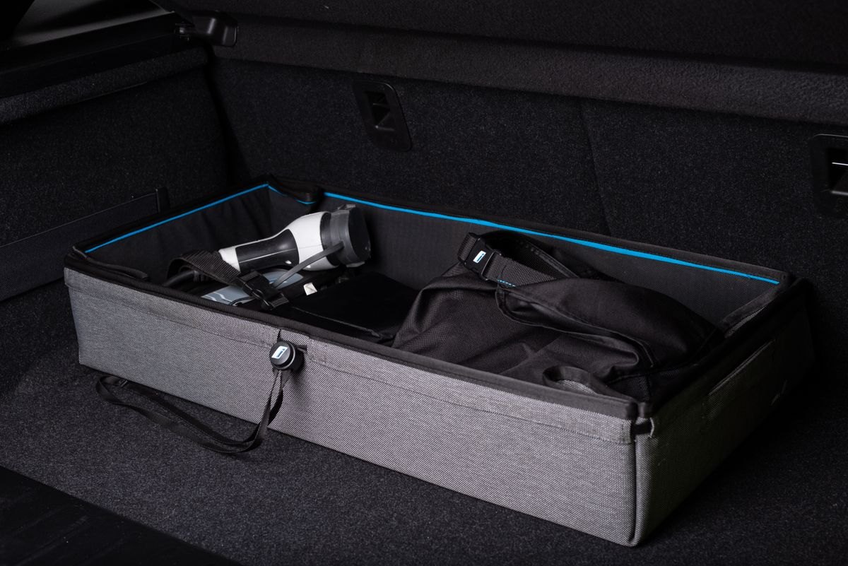 Storage box and travel equipment organized in a car trunk
